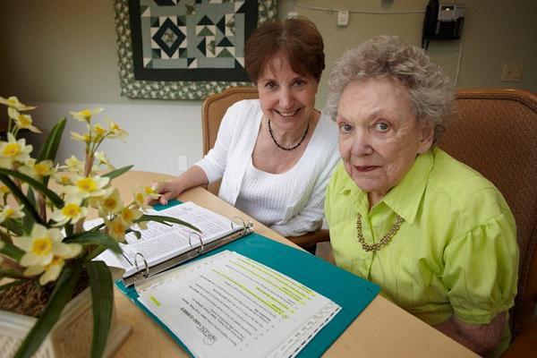 Older woman talking with a nurse about her care