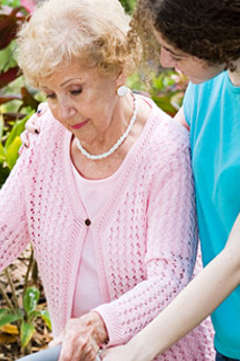 nurse helping older woman walk