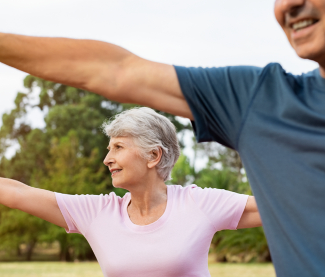 senior couple doing yoga outside