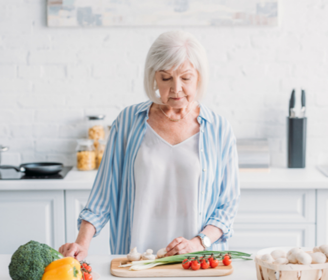 sad woman cutting vegetables