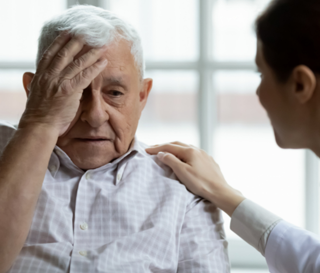 physician attending to dizzy man