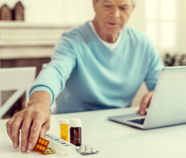 older man reaching for medication