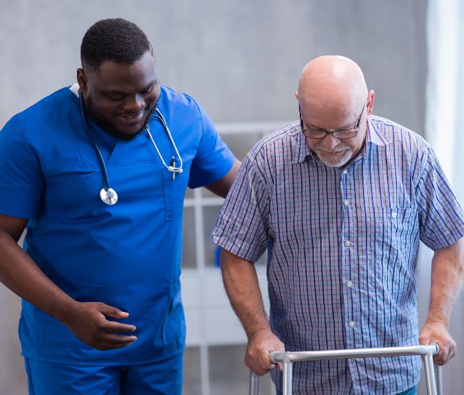 caregiver helping older man walk