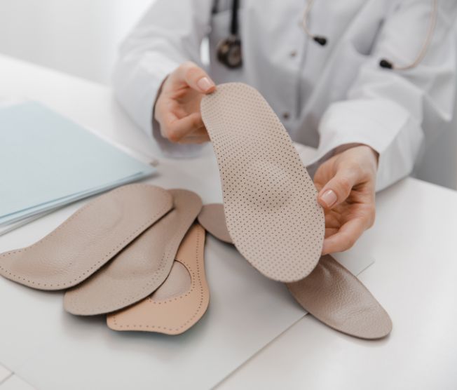 doctor holding custom shoe insert