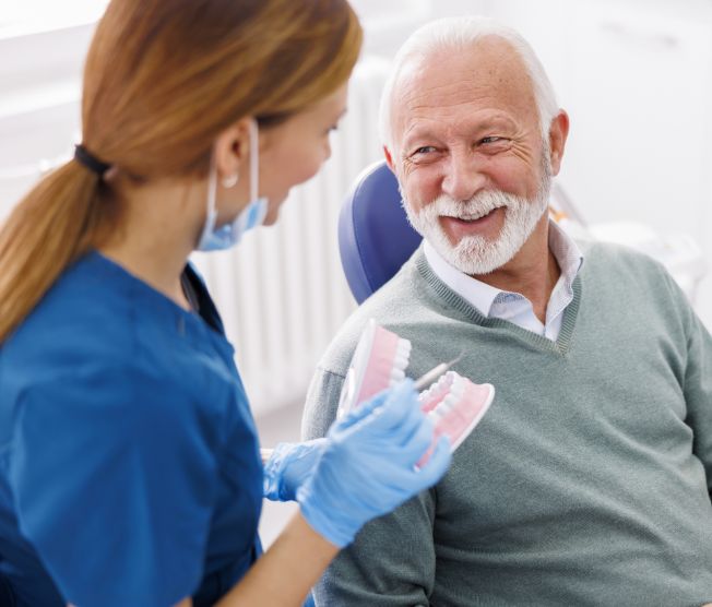 dentist explaining procedure to senior patient